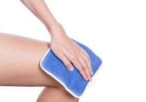 Applying cold compress to knee