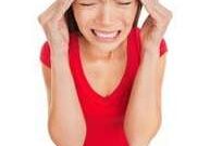 Woman holding head, feeling stressed