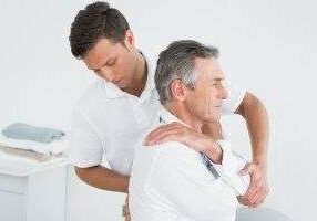 Physiotherapist treating shoulder pain