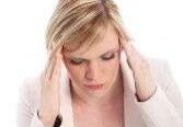 Woman with headache touching temples
