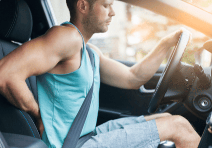 Driver experiencing back pain while driving