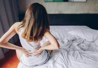 Morning backache in bedroom setting.