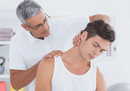 Chiropractor treating a young man's neck