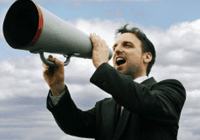 Man shouting through megaphone outdoors