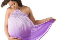 Expectant mother holding dress