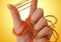 Hand with rubber bands on fingers