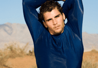 Individual posing with arms raised